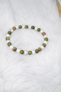 Beaded stretch bracelet with green unakite and white howlite beads, elastic design