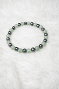Green and dark hematite beaded stretch bracelet with round beads and dark metal-look accents