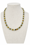 Beaded stretch necklace with green and gold round beads on bust display