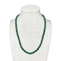 Emerald green and dark gray beaded stretch necklace on mannequin bust