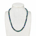 Beaded stretch necklace with round blue, teal, and dark hematite-style beads on a cord