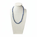 Lapis lazuli beaded stretch necklace on bust mannequin, dark blue round stones