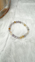 Stretch beaded bracelet with translucent lilac and clear beads, small golden accents