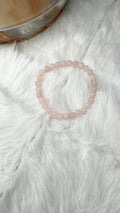Round pink rose quartz bead stretch bracelet on soft white fur