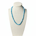 Blue gemstone beaded stretch necklace on a display bust, round beads
