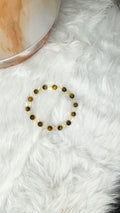 Gold and brown beaded stretch bracelet with small round tiger eye and citrine beads