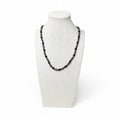 Black onyx and bronzite beaded stretch necklace on mannequin, dark round beads
