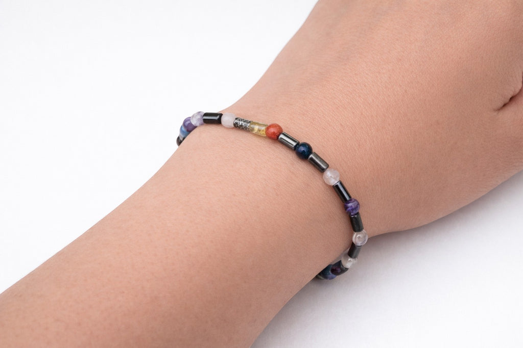 Shop of Small Creations, LLC 7 chakra beaded stretch bracelet with hematite spacers, featuring 4mm natural gemstones for balance and grounding.